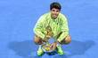 Carlos Alcaraz of Spain celebrates with the trophy after winning the men's singles final a...