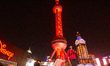 The Shanghai Pearl TV Tower lights up red during the Chinese Lunar New Year holiday at Luj...
