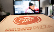 A box of pizza with the logo of Pizza Hut is in front of a TV in Athens, Greece, on Februa...