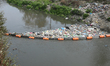 In Kathmandu, Nepal, on February 24, 2026, trash barriers installed in rivers across Kathm...