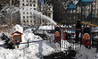 Park employees clear snow from the children's playground at Madison Square Park in New Yor...