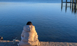 A woman sits with a coffee to go at Starnberger See during the first spring temperatures i...