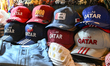 DOHA, QATAR – FEBRUARY 18:  Stacks of souvenir baseball caps featuring Qatar and Doha bra...