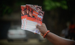 A man holds flyers during the Rotary Club of Ikeja-Alausa bicycle ride, tagged ''2026 Peda...