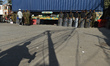 Security personnel stand alert as police block the main road leading to the US Consulate w...