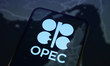 The OPEC (Organization of the Petroleum Exporting Countries) logo appears on a smartphone...
