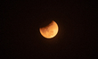 A total lunar eclipse, known as a ''Blood Moon,'' is visible from a banana plantation in T...