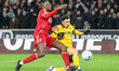 Rodrigo Gomes of Wolverhampton Wanderers competes to reach the ball ahead of Ibrahima Kona...