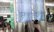 A departure board displays flight cancellations at Soekarno-Hatta International Airport af...