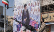An armed military member of the Islamic Revolutionary Guard Corps (IRGC) stands guard behi...
