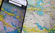 Flightradar24 map showing current air traffic in the Middle East dislplayed on a laptop an...