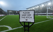 A sign asks to keep off the grass on the pitch before the Premier League match between Ful...