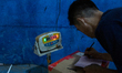 Workers weigh shipments at the LJR warehouse in Jakarta, Indonesia, on March 4, 2026. As t...