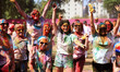 Tourists are smeared in 'gulal' colors during an event organized by Rajasthan Tourism for...