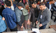 Interim Prime Minister Sushila Karki checks her name on the voter list before casting her...
