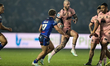 Zak Hardaker runs past Harvey Smith during the BetFred Super League match between Wakefiel...