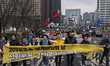 Union members march behind a main banner that reads ''2026.3.8. International Women's Day:...