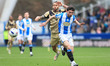 Sean Roughan of Huddersfield holds off Sam Nombe during the Sky Bet League 1 match between...