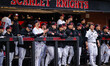 The Rutgers Scarlet Knights dugout reacts during an NCAA baseball game at Bainton Field in...