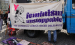 Participants with banners and signs gather during the International Women's Day rally at R...