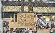 A sign reads ''3 Worte, Nein zum Krieg'' (Three words: No to war) at the revolutionary dem...