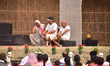People enjoy open-air drama in Nagaon District, Assam, India, on March 8, 2026, during the...
