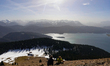 Hikers rest on the slope of Jochberg mountain overlooking Lake Walchensee in Jachenau, Bav...