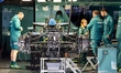 Mechanics work on the car of Formula 1 driver Fernando Alonso of the Aston Martin Aramco F...