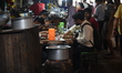 In Kolkata, India, on March 12, 2026, street food vendors cook using coal-fired ovens amid...