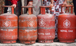 Nepali consumers wait in line carrying empty LPG cylinders as they rush to gas depots to r...