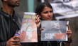 In Kathmandu, Nepal, on March 12, 2026, Dalit rights activists and youths hold placards du...