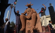 Protesters carry an effigy labeled ''Baal'' before setting it on fire during a rally marki...