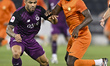 Paulo Silva of Al Sadd SC and Jean Kouassi of Umm Salal SC are in action during the Qatar...