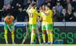 Ali Ahmed of Norwich City celebrates scoring his team's first goal with teammates during t...