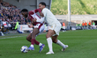 Northampton Town's Kamarai Swyer is challenged by Burton Albion's Toby Sibbick during the...