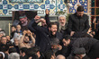 Unidentified men mourn while shouting slogans during a funeral for Ali Shamkhani, the secr...