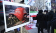 A satirical banner is displayed during a rally near the United States Consulate as part of...