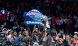 St. John's Red Storm players celebrate while holding the BIG EAST Men's Basketball Tournam...