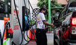 A gas station attendant refuels a truck at a Bangchak Corporation Public Company Limited s...