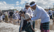 A Balinese woman is in a trance during a Melasti ceremony at Petitenget Beach on the islan...
