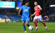 Kyrell Lisbie of Peterborough United is challenged by Joe Rafferty of Rotherham United dur...