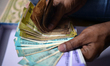 A man counts Indian currency in Siliguri, India, on March 18, 2026. The Indian rupee reach...