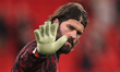 Liverpool goalkeeper Alisson Becker waves to the fans during the pregame warmup session be...