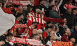 Liverpool fans hold up their scarves as they sing a rendition of ''You'll Never Walk Alone...
