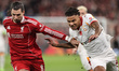 Dominik Szoboszlai of Liverpool holds off Ismail Jakobs of Galatasaray during the UEFA Cha...