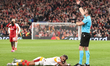 Referee Szymon Marciniak calls for the medical team for Mario Lemina of Galatasaray during...