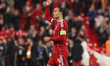 Virgil van Dijk of Liverpool celebrates with fans in the Kop during the UEFA Champions Lea...