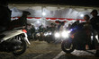 Thousands of motorcycle travelers wait in line to enter the ticket counter area at Ciwanda...