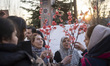 A family looks at flowers during New Year shopping in northern Tehran, Iran, on March 18,...