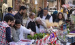 People shop for New Year decorations from a street vendor during New Year shopping in nort...